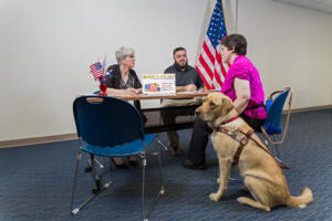 Register to Vote booth with disability dog.