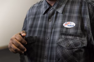 Plaid shirt with I Voted sticker