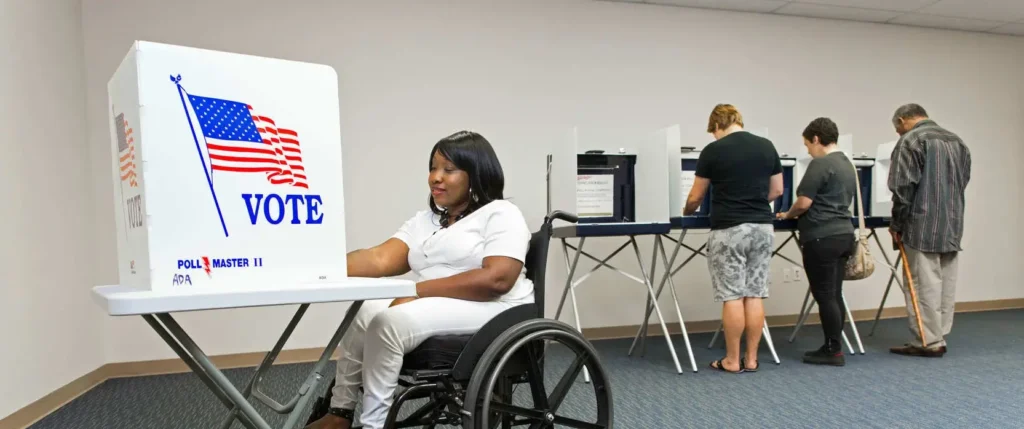 wheelchair user voting at foldable table